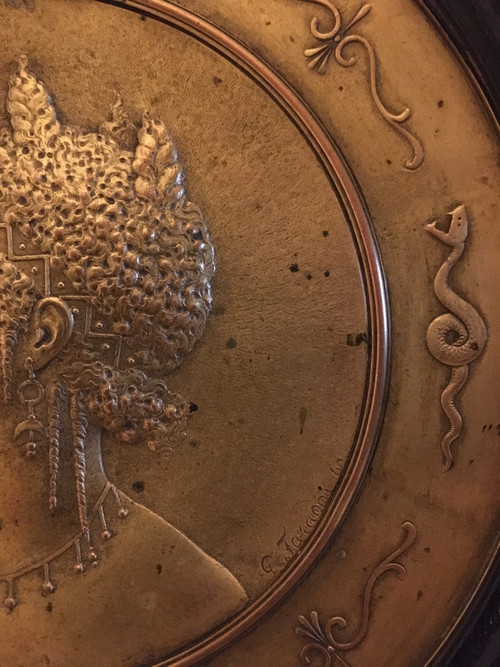 Pair of chased and gilded copper medallions, signed P. Faraoni (1869)