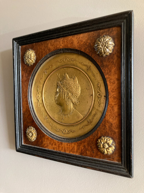 Pair of chased and gilded copper medallions, signed P. Faraoni (1869)