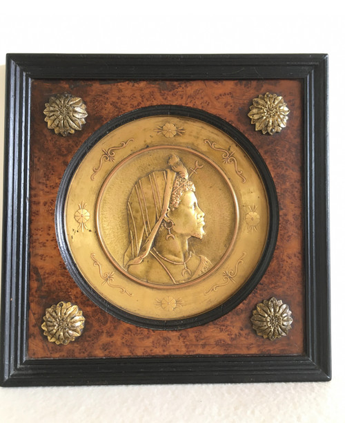 Pair of chased and gilded copper medallions, signed P. Faraoni (1869)