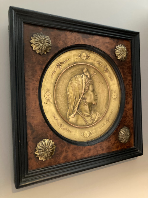 Pair of chased and gilded copper medallions, signed P. Faraoni (1869)