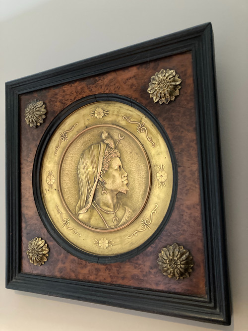 Pair of chased and gilded copper medallions, signed P. Faraoni (1869)