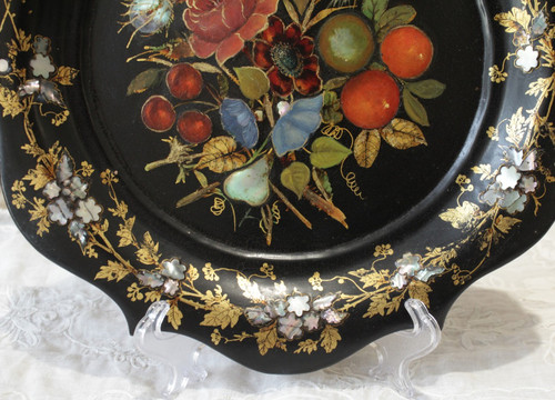 Rounded platter in painted black pressed material with mother-of-pearl inlay late 19th century