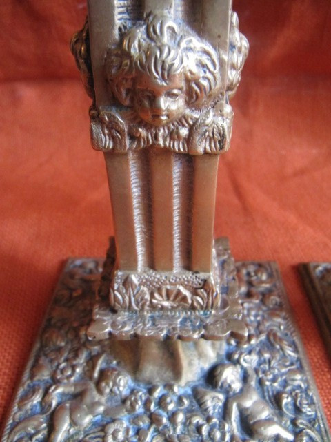 Pair of bronze candlesticks decorated with cherubs 19th century