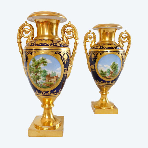 Pair of Empire vases in blue and gilded porcelain of Paris, decorated with landscapes