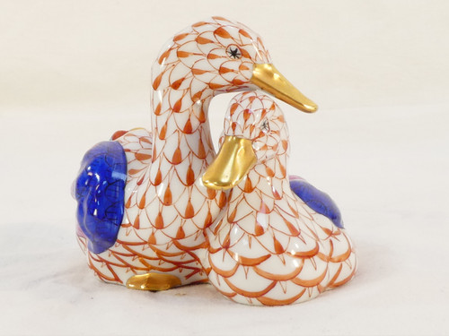 Couple of white porcelain ducks with orange fish scale net pattern 