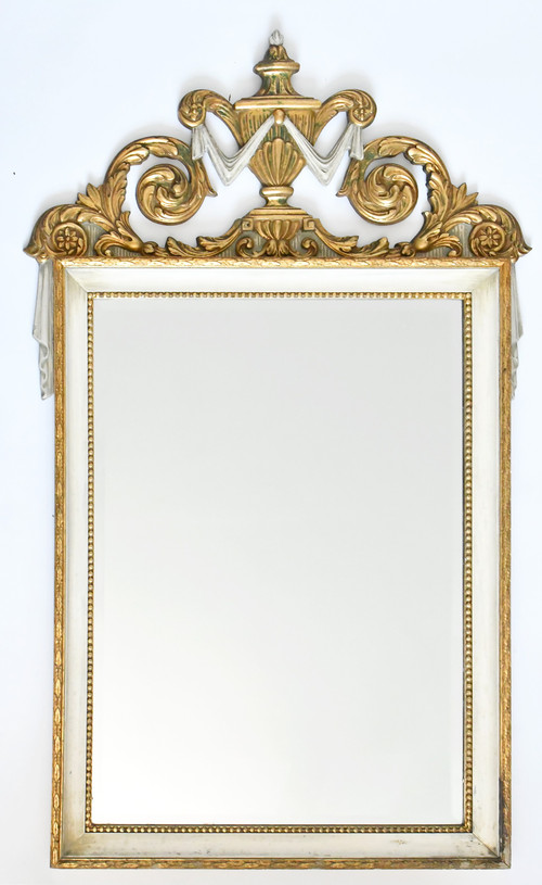 White and gold lacquered wood mirror with carved wooden pediment decorated with a basin