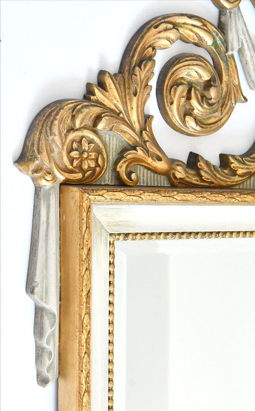 White and gold lacquered wood mirror with carved wooden pediment decorated with a basin