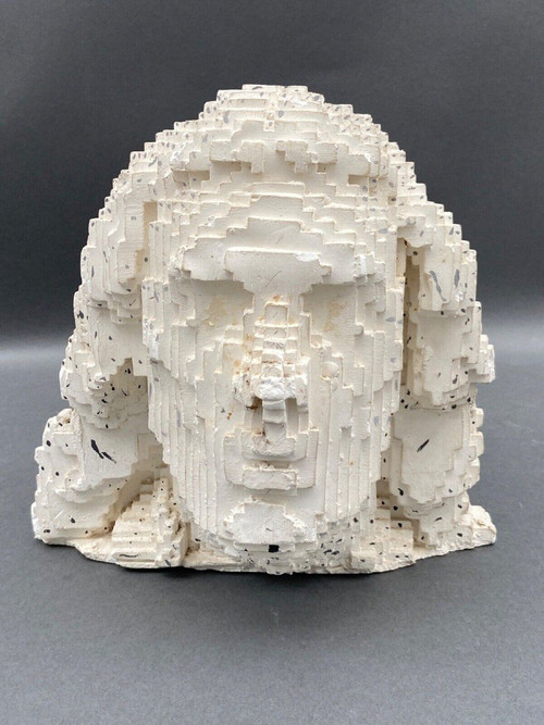 Sculpture in cellular concrete, pixelation of a man's face 1970