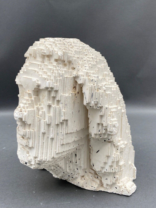 Sculpture in cellular concrete, pixelation of a man's face 1970