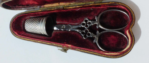 Small pair of steel embroidery sewing scissors in its 19th century leather-covered case