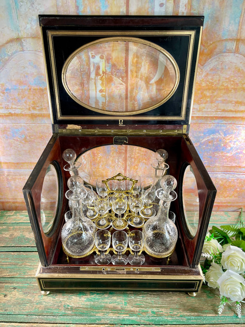 Napoleon III liqueur cellar in black wood, with brass fillets and chased glass portholes