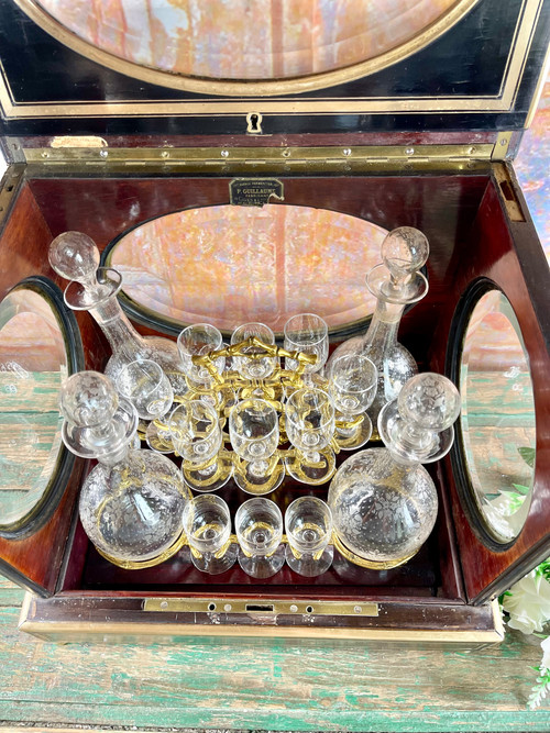 Napoleon III liqueur cellar in black wood, with brass fillets and chased glass portholes