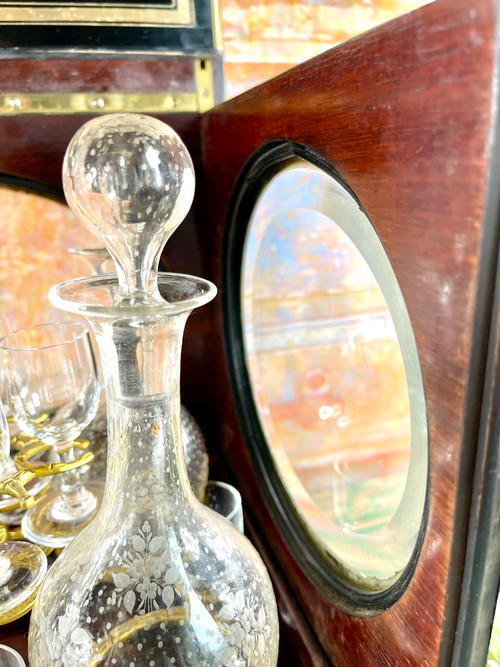 Napoleon III liqueur cellar in black wood, with brass fillets and chased glass portholes