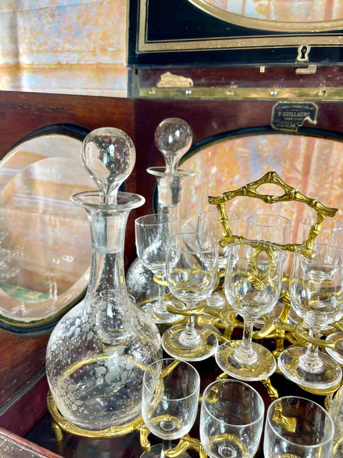 Napoleon III liqueur cellar in black wood, with brass fillets and chased glass portholes