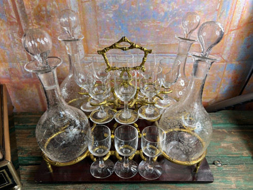 Napoleon III liqueur cellar in black wood, with brass fillets and chased glass portholes