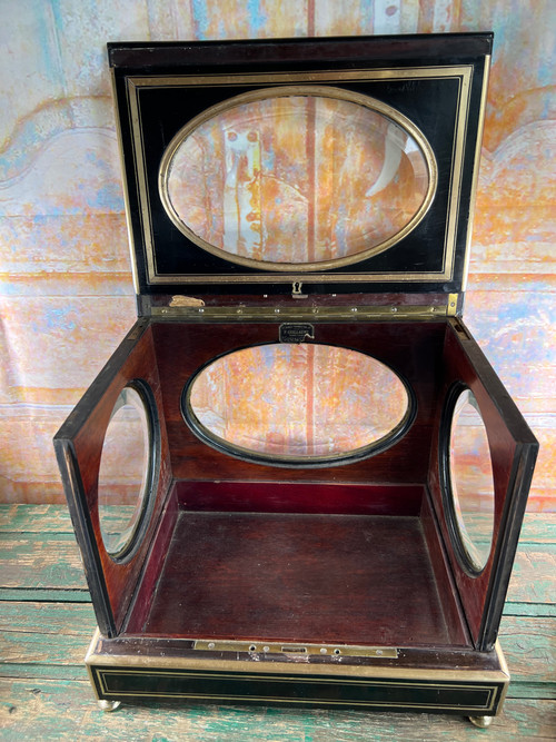 Napoleon III liqueur cellar in black wood, with brass fillets and chased glass portholes