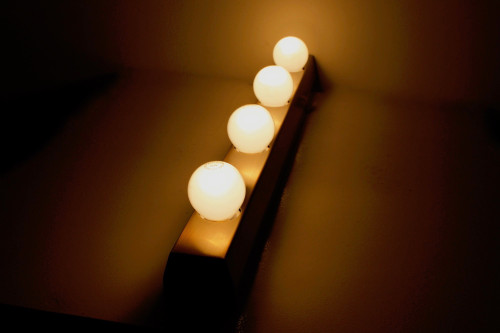 “Vanity lamp” dressing room wall lights, bronze finish.