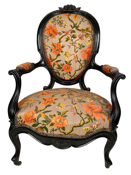 Pair of Napoleon III armchairs, in blackened wood, upholstered in floral fabric.