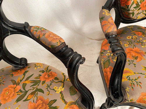 Pair of Napoleon III armchairs, in blackened wood, upholstered in floral fabric.