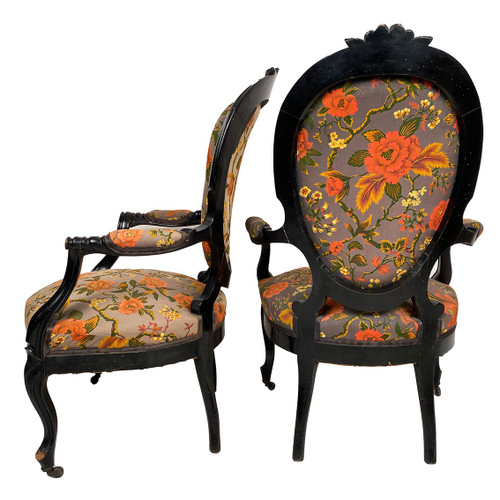 Pair of Napoleon III armchairs, in blackened wood, upholstered in floral fabric.