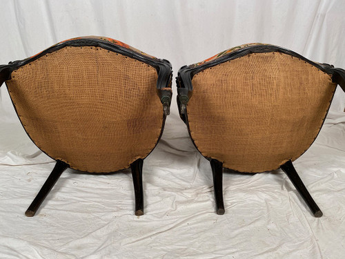 Pair of Napoleon III armchairs, in blackened wood, upholstered in floral fabric.