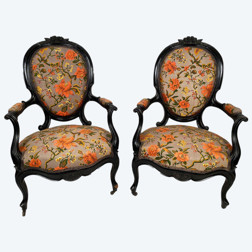 Pair of Napoleon III armchairs, in blackened wood, upholstered in floral fabric.