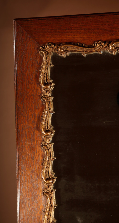 Original framed mirror in oak and gesso in the rococo style.