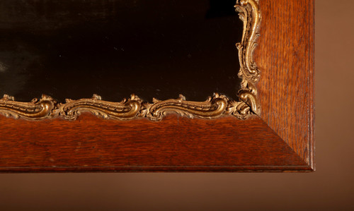 Original framed mirror in oak and gesso in the rococo style.