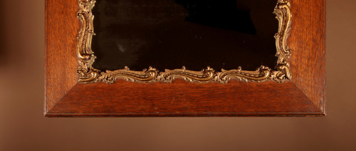 Original framed mirror in oak and gesso in the rococo style.