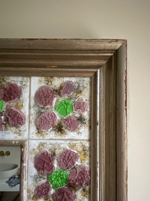 Large square ceramic mirror with floral decoration.