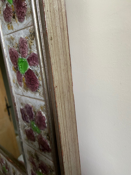 Large square ceramic mirror with floral decoration.