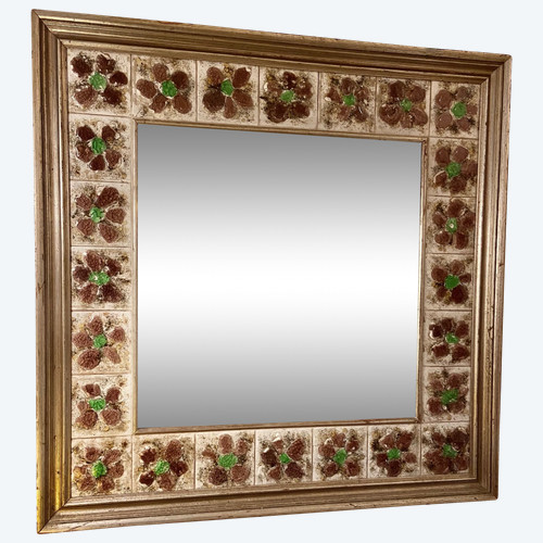 Large square ceramic mirror with floral decoration.