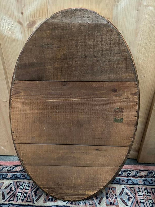 Oval mirror in gilded wood