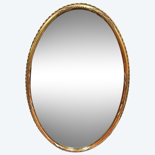 Oval mirror in gilded wood