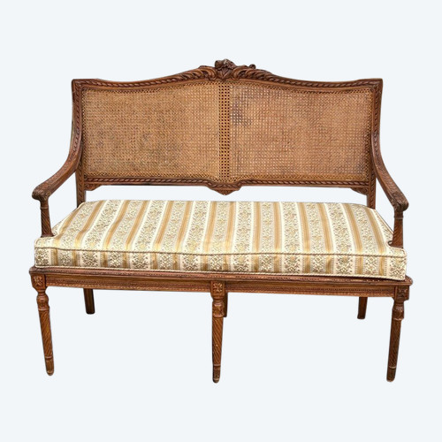 LOUIS XVI STYLE CARVED WALNUT CANE BENCH FROM THE 1900S