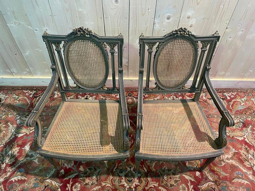 Pair of Louis XVI armchairs with re-edging and caning.
