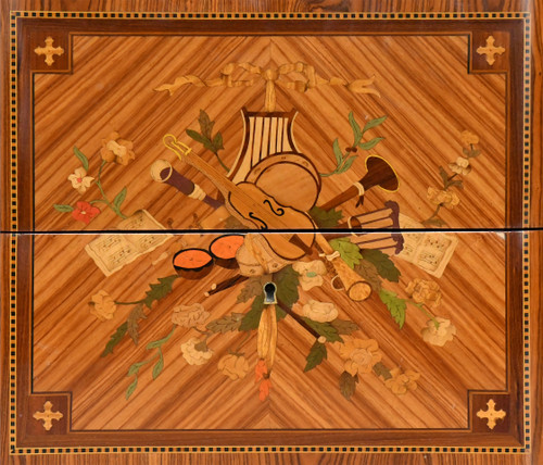 Commode de style Transition en marqueterie à décor de trophée aux instruments de musique 