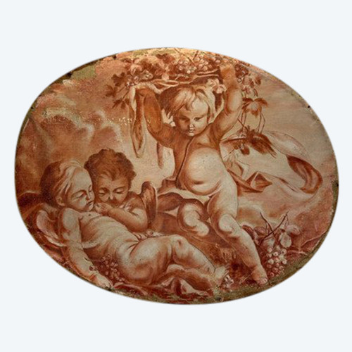 OIL ON OVAL WOOD PANELING DECORATED WITH CHERUBS CARRYING A FRUIT BOWL