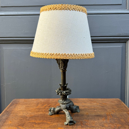 Restoration period lamp with tripod base and dolphin and cherub heads