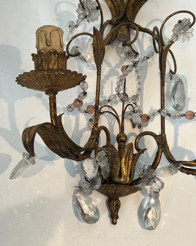 Pair of wall lights in gilded metal and crystals. French work in the style of Maison Baguès.