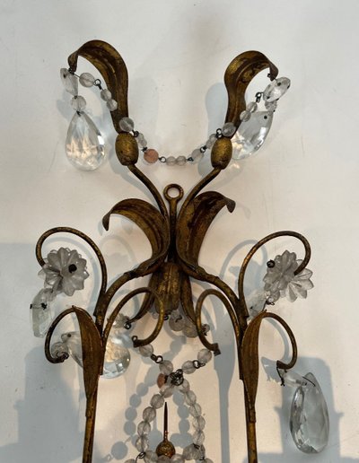 Pair of wall lights in gilded metal and crystals. French work in the style of Maison Baguès.