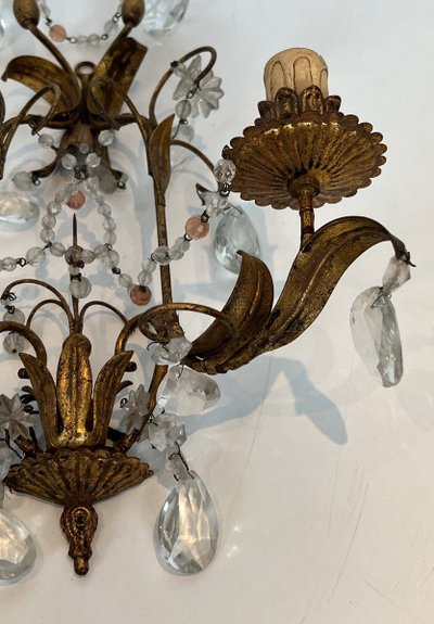 Pair of wall lights in gilded metal and crystals. French work in the style of Maison Baguès.