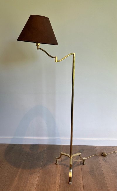 Brass reading lamp with removable, height-adjustable arm.