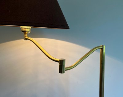 Brass reading lamp with removable, height-adjustable arm.