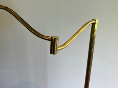 Brass reading lamp with removable, height-adjustable arm.