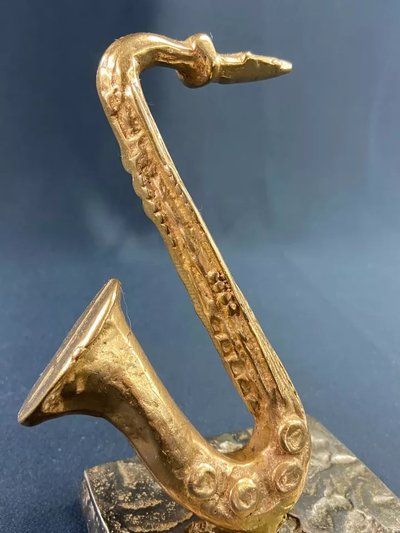 Carved saxophone subject in bronze signed Yves Lohé