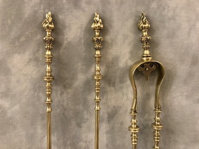 Set of three bronze and brass fireplace accessories from the 19th century.
