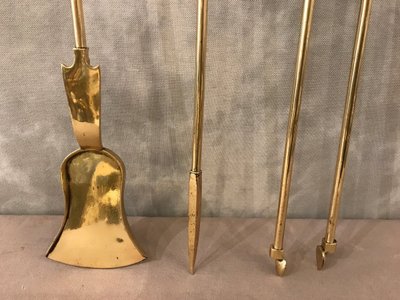 Set of three bronze and brass fireplace accessories from the 19th century.