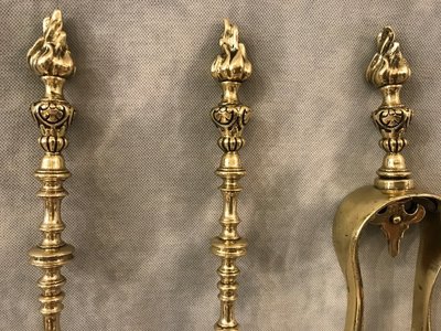 Set of three bronze and brass fireplace accessories from the 19th century.