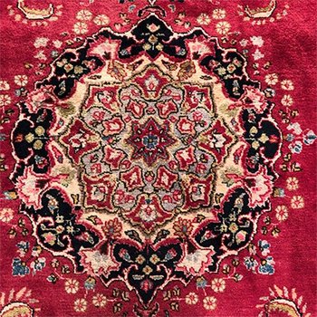 Iranian wool carpet with central medallion decoration on pink background